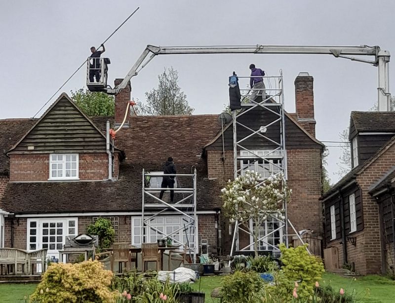 The Roof Moss Cleaners using cherry picker and scaffolding to clean roof safely and professionally in Houghton Regis, Bedfordshire